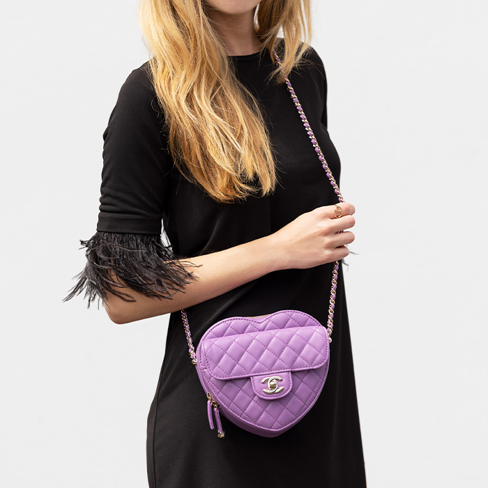 lifestyle image of model wearing chanel cc in love heart bag as a crossbody bag FASHIONPHILE