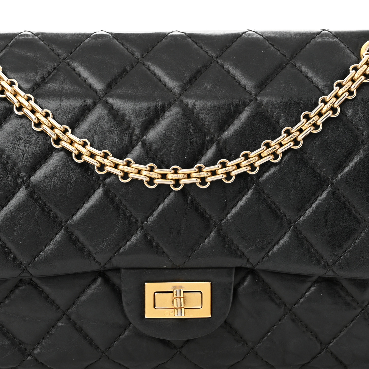 This is an image from FASHIONPHILE of a CHANEL Aged Calfskin Quilted 2.55 Reissue flap bag in size 226 in the color Black